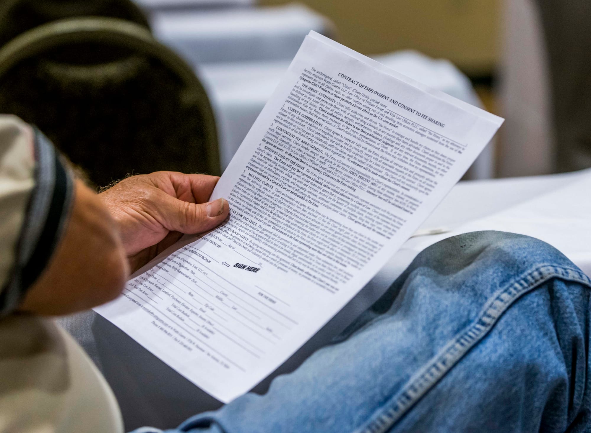 A farmer holds a legal agreement at the Hilton Garden Inn in Champaign, Ill., on Sept. 1, 2015.