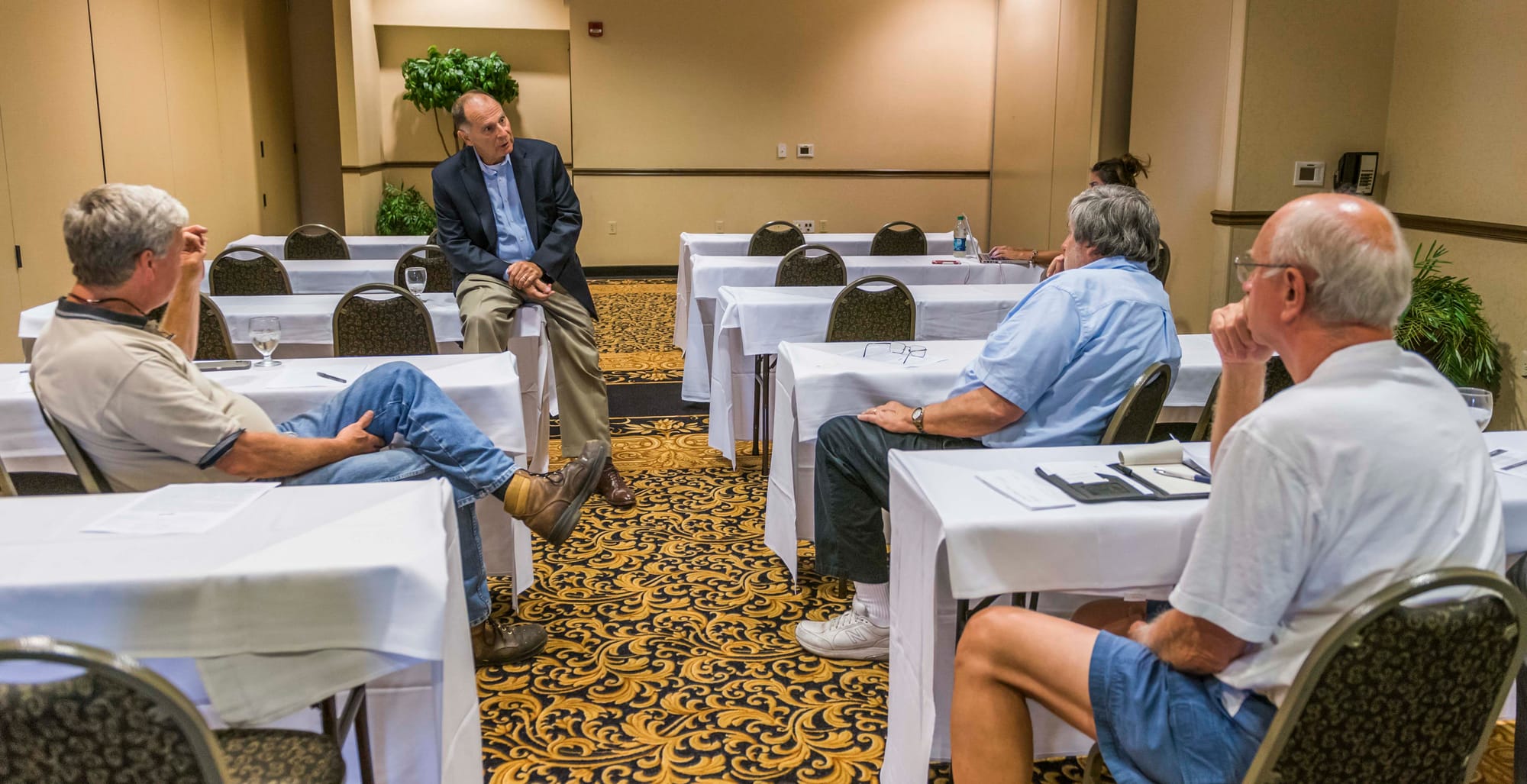 Former congressman and currenty lawyer Bill Enyart talks with farmers at the Hilton Garden Inn on Sept. 1, 2015. Enyart was advising farmers considering joining lawsuits against Syngenta. 