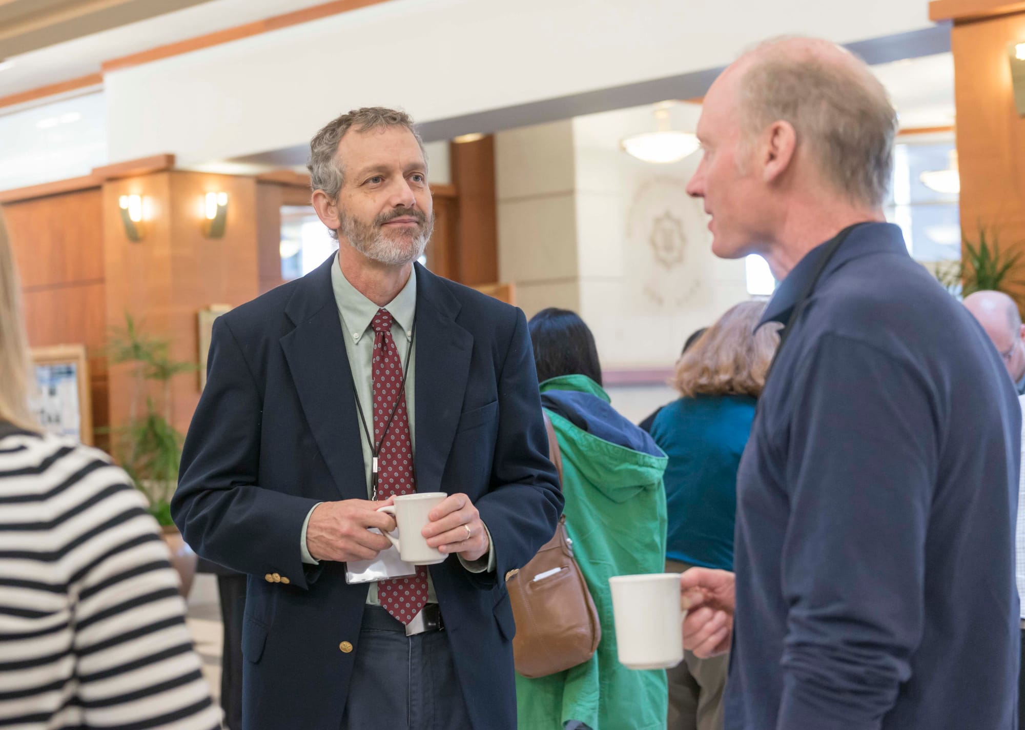 Conference presenter Mark David (left) talks with other attendees at the ISEE Congress 2015 in Urbana, Ill., on Sept. 15, 2015.