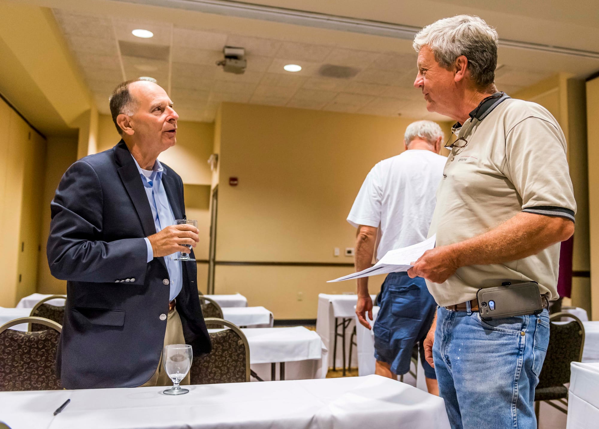 Lawyer and former U.S. representative Bill Enyart talks with farmer Dennis Riggs at the Hilton Garden Inn in Champaign, Ill., on Sept. 1, 2015.