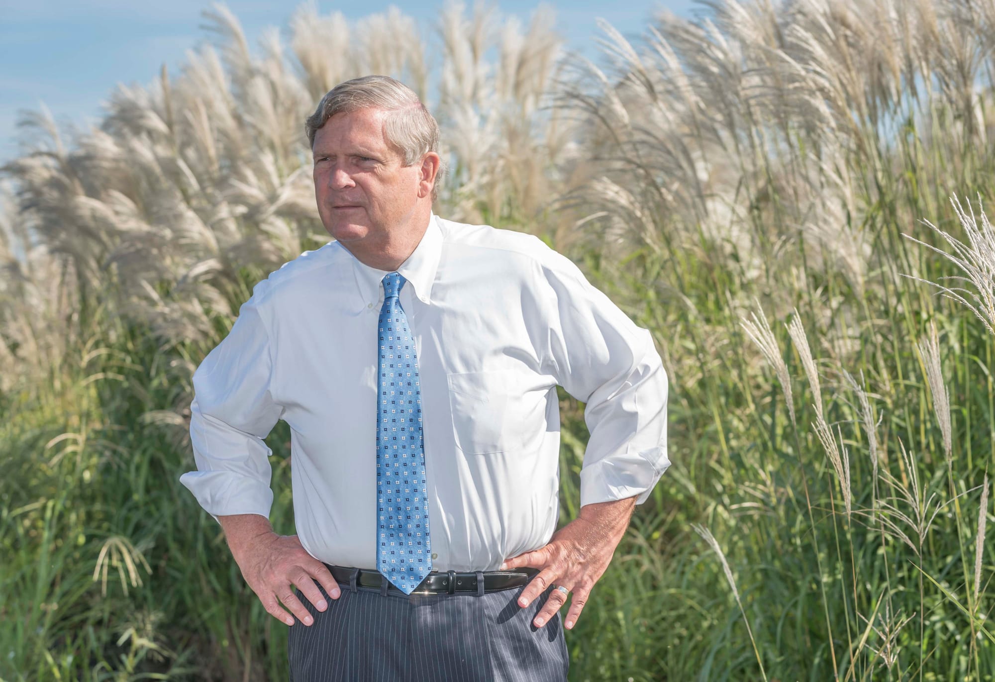 U.S. Secretary of Agriculture Tom Vilsack listens to a researcher on Sept. 10, 2015. He was at the UI Energy Farm just south of  Urbana, Illinois. 