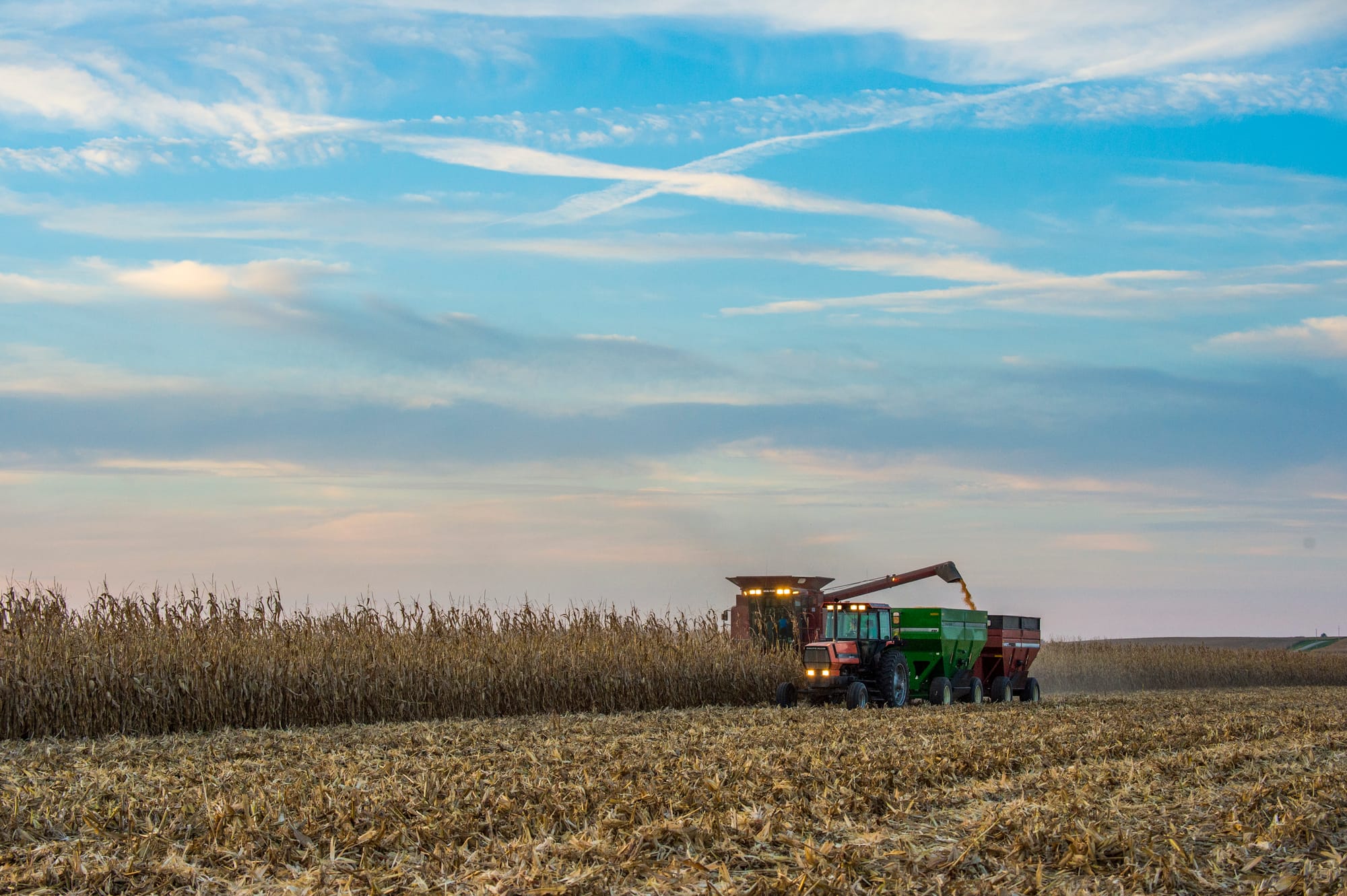 A central Illinois farmer harvests his corn field on a sunny day on Sept. 24, 2015. Many experts believe that the American agriculture industry will gain the most from the Trans-Pacific Partnership trade deal.