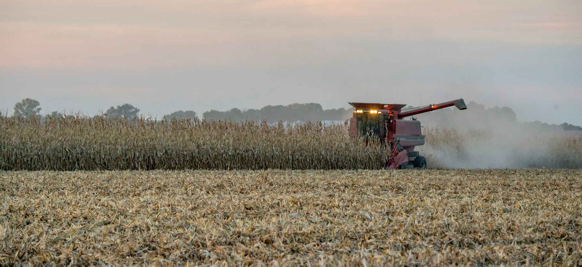 A central Illinois farmer harvests his crop as grain particles fly behind the tractor on Sept. 24, 2015. Besides the United States, Trans-Pacific Partnership countries include Japan, Mexico, Canada, Chile, Australia and six other countries.