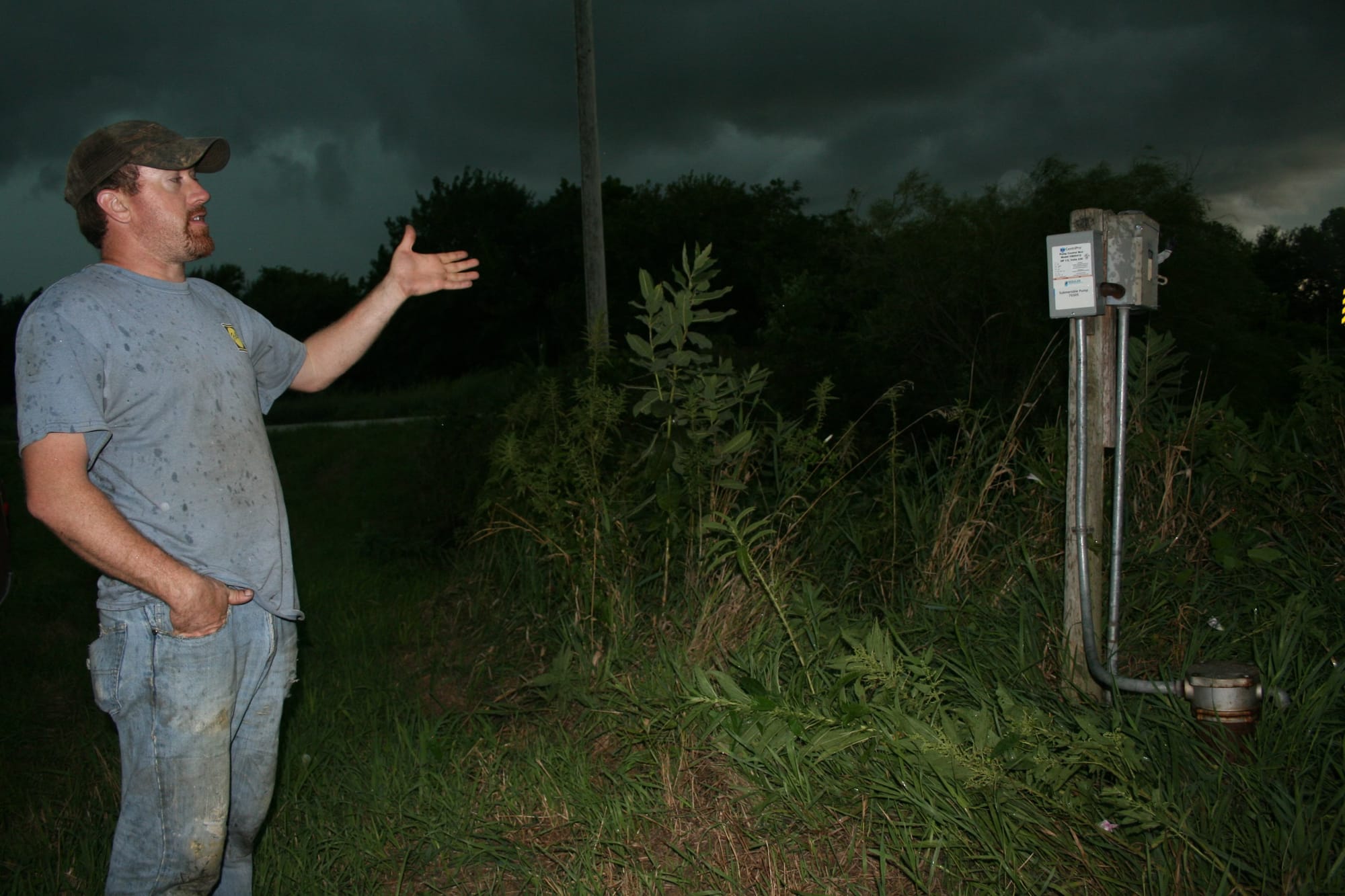 Craig Melvin talks about his well, located in a field a short distance from his house in Farragut, Iowa, on Aug. 19, 2016.