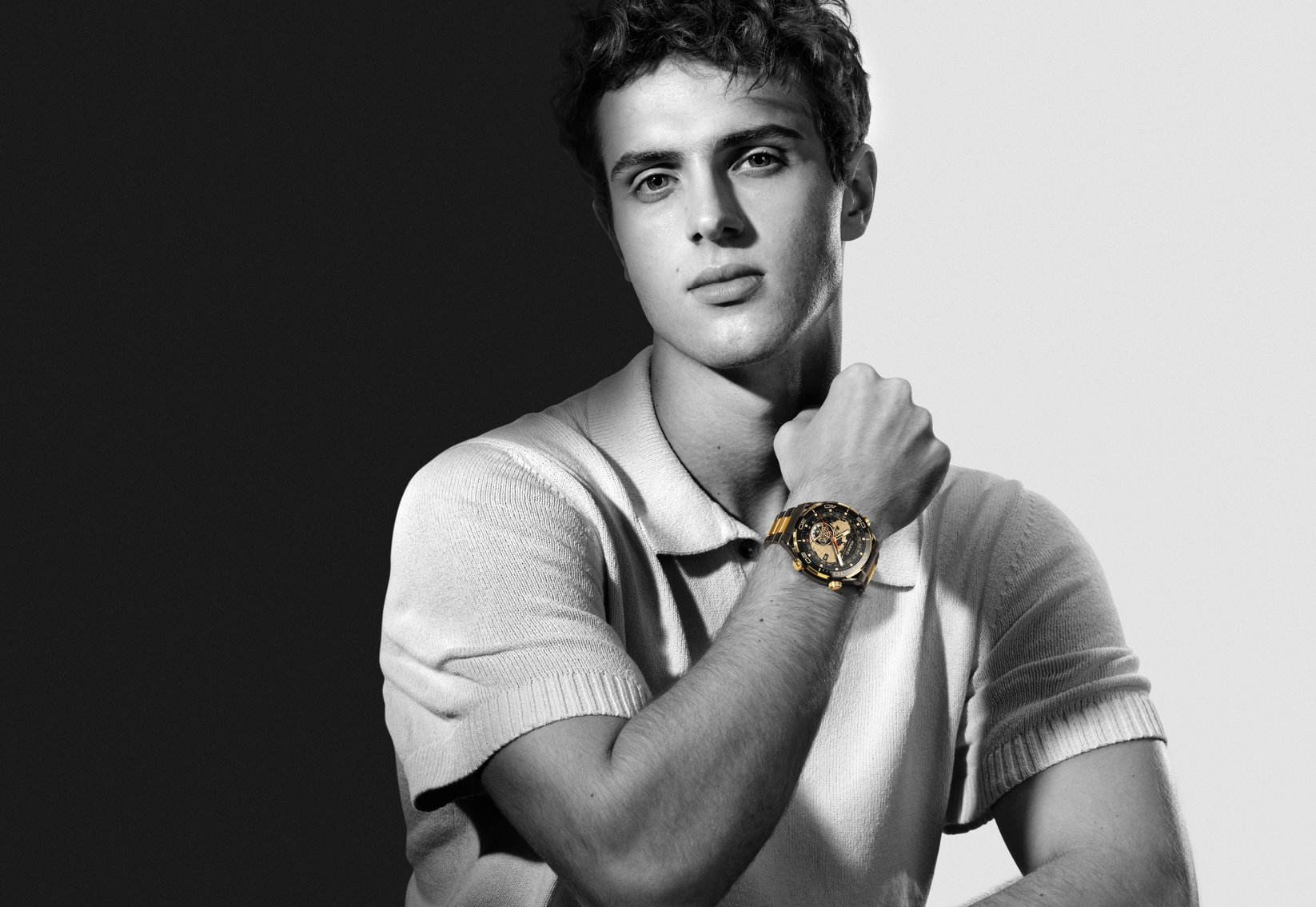 A person with a watch on his wrist
Description automatically generated