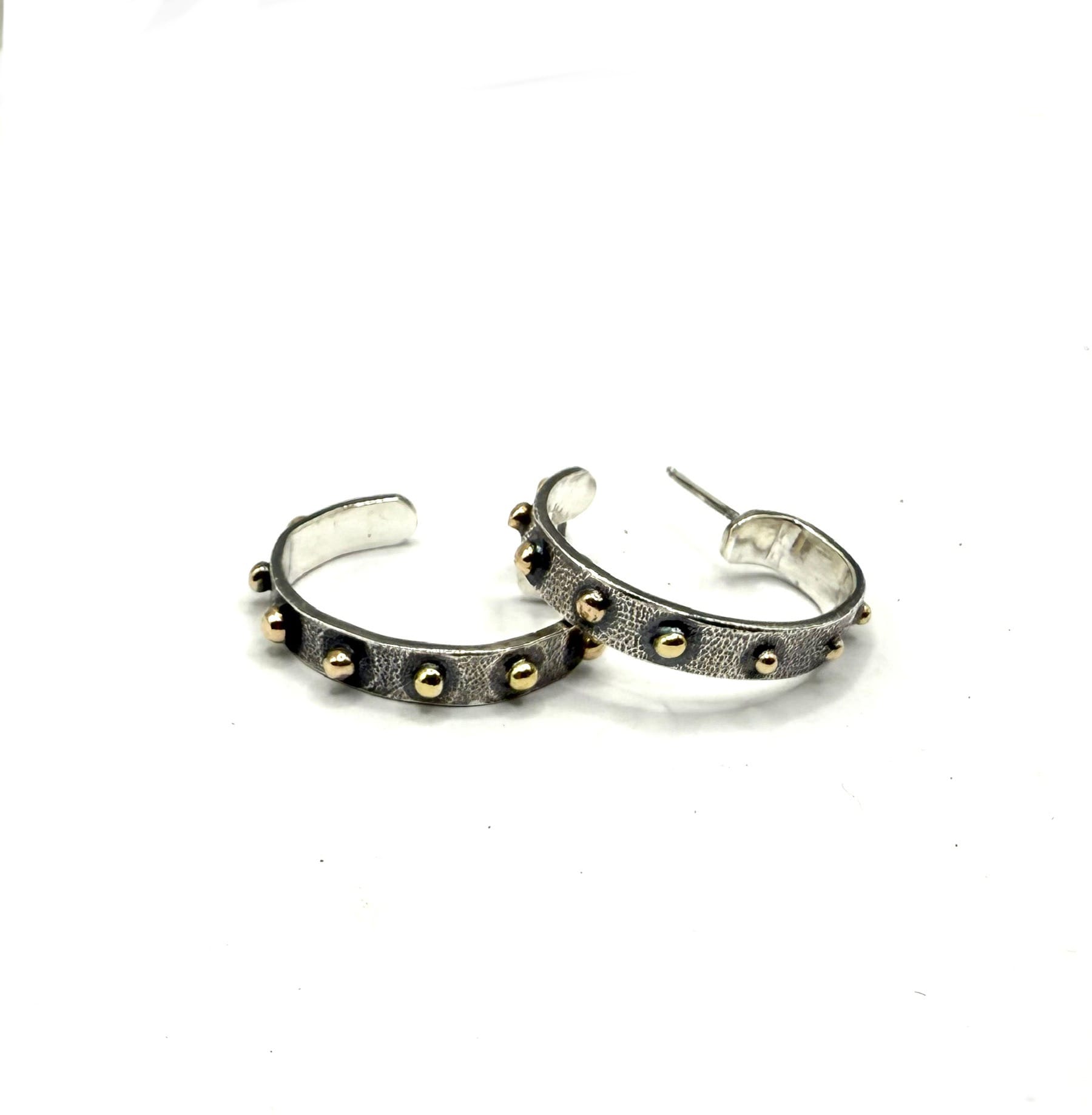 Hand forged sterling hoops with 14 karat yellow gold granules