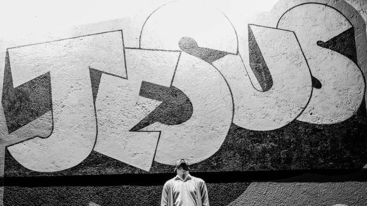 Man looking up at Jesus wall.