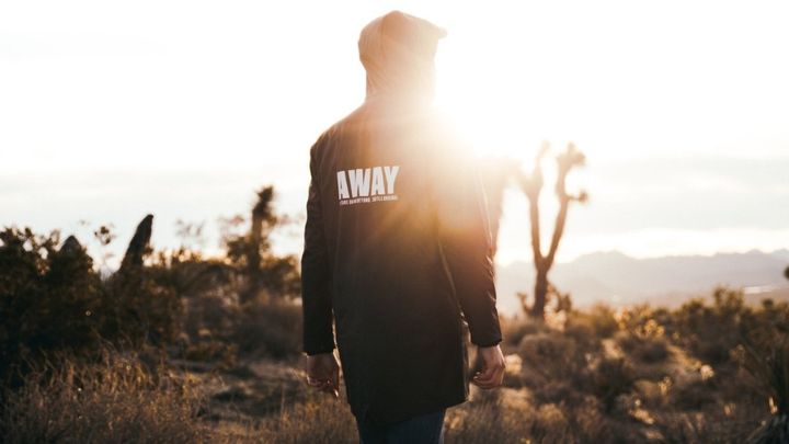 Man walking away towards the Sun.