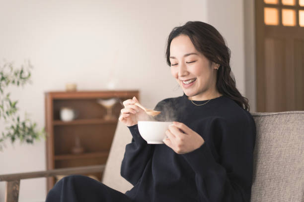 Learn fall nouns in Chinese - an image of a woman drinking hot soup