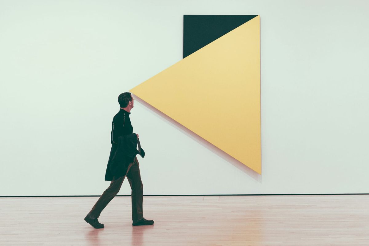 View of a contemporary art gallery interior with visitors.