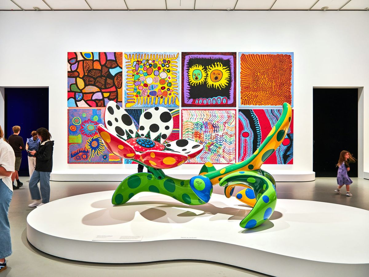 Visitors observing artwork quietly in a museum gallery