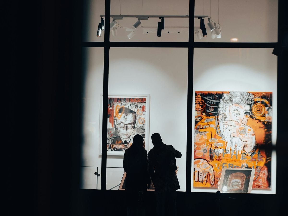 Contemporary gallery exterior with visitors viewing artworks