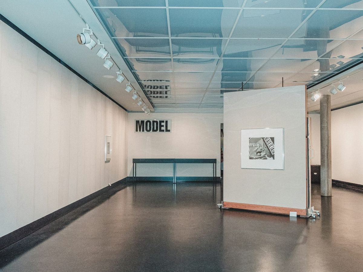 A small gallery preparing for a phased exhibition opening during a congested art season.