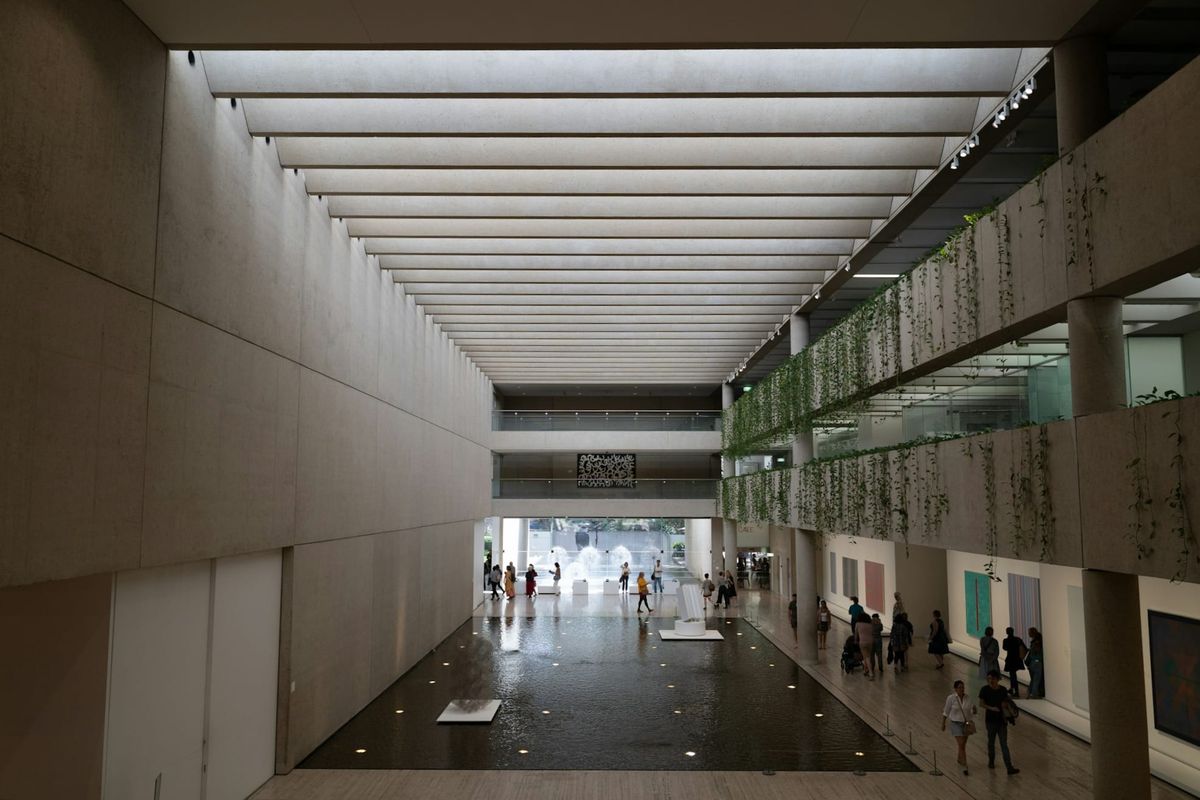 Minimal architectural interior with layered corridors and converging lines, suggesting consolidated authority and structured passage.