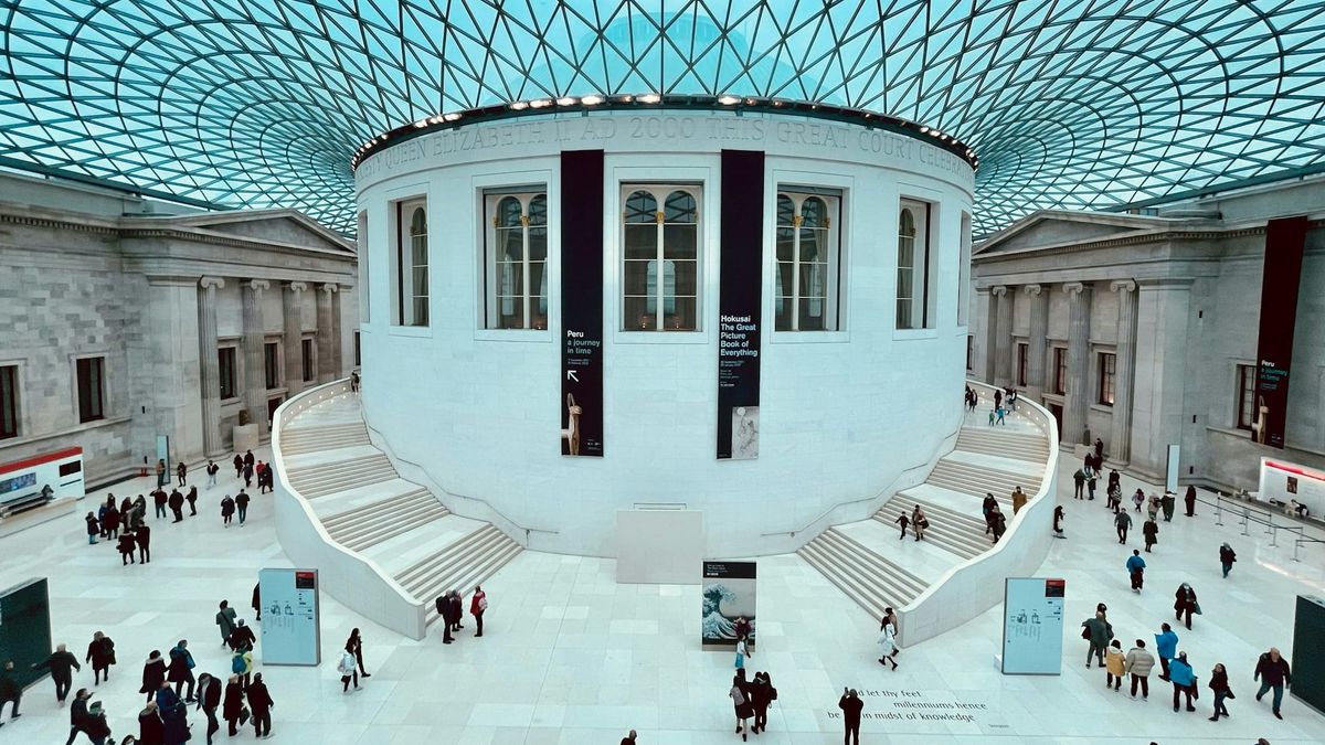 The British Museum in London with visitors near the main entrance.