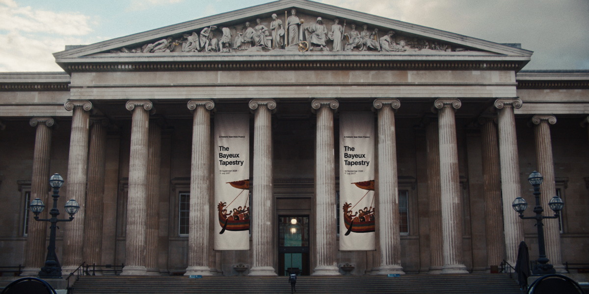 Exterior of the British Museum with banners for The Bayeux Tapestry exhibition hanging between the columns.