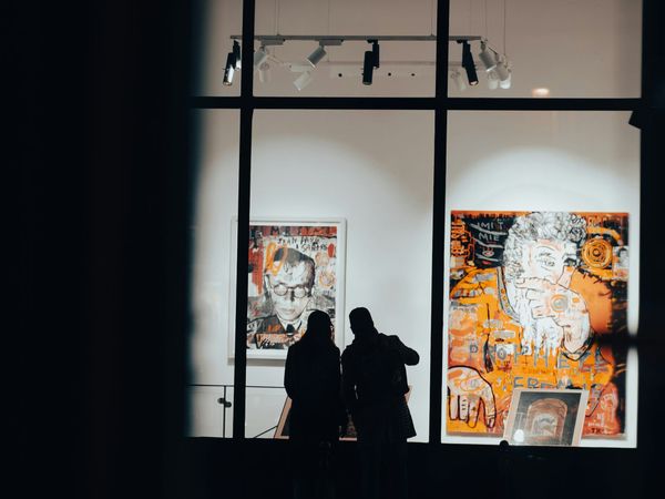 Contemporary gallery exterior with visitors viewing artworks