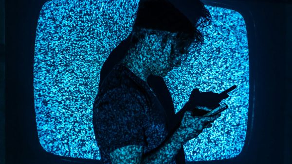 Conceptual image of a person’s silhouette with neural light patterns, symbolizing the brain’s calm reactivation during deep visual focus