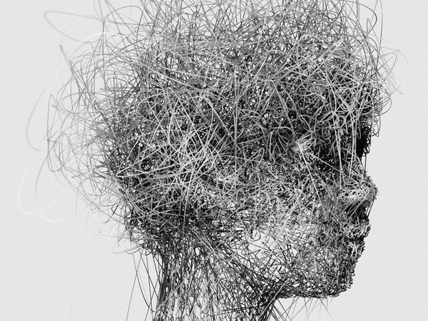 Abstract human head formed from tangled lines, suggesting cognitive overload and mental pressure.