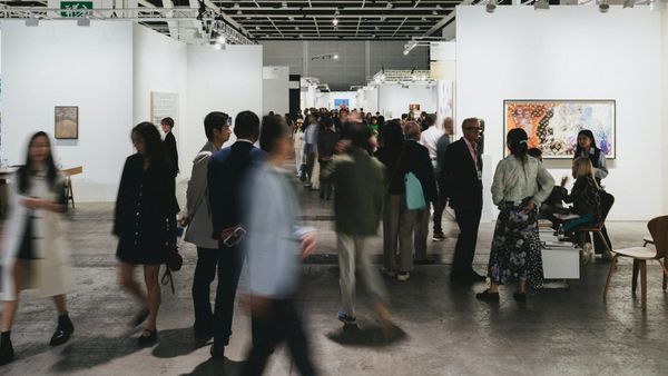 Collectors and galleries navigating an art fair environment where visibility, pacing, and positioning are carefully managed.