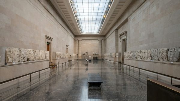 Interior view of the British Museum gallery with antiquities on display, highlighting classical sculptures and architectural space.