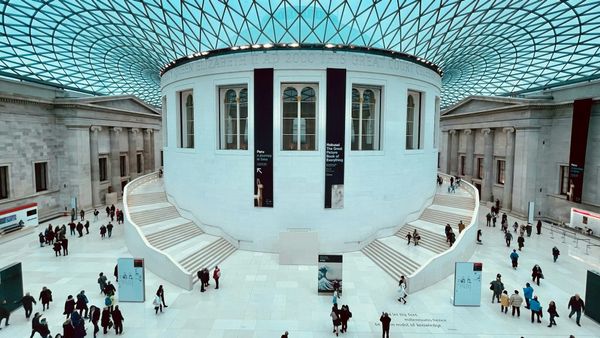 The British Museum in London with visitors near the main entrance.