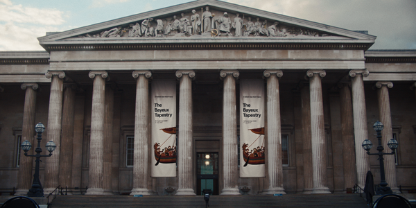 Exterior of the British Museum with banners for The Bayeux Tapestry exhibition hanging between the columns.