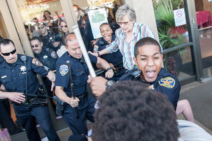 Police use force as demonstrators storm the entrance of Conlan Hall