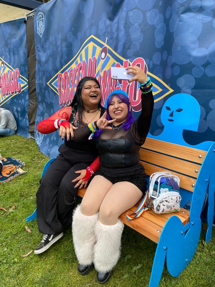 Two women taking cell phone selfies.