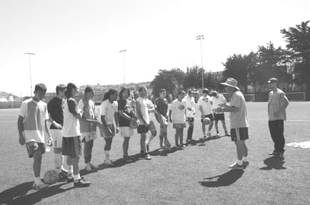 Coach Lucarelli instructs the team during practice.