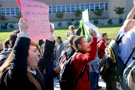 Katie Dalla (left), part of a crowd of about 200, marches around Cloud Circle during the City College budget cuts walkout on Nov. 18. The march ended with a protest at Conlan Hall.