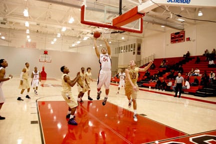 Rams freshman forward Hamilton Chang (center) goes high for a lay up over Dons defenders during the Rams' 94-75 victory  over De Anza College on Dec. 5 at the Wellness Center. RAMSEY EL-QARE / THE GUARDSMAN