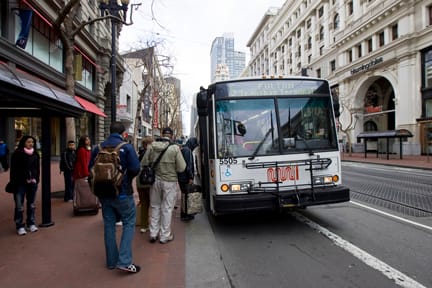Passengers board Muni's 5 line at Market and Powell streets on Feb. 8. Muni riders face increased fares and fewer buses. JOSEPH PHILLIPS / THE GUARDSMAN