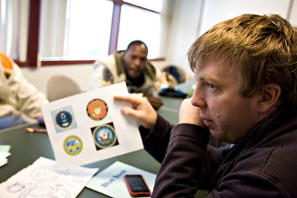 City College student veteran Stuart Rhodes show four military branch emblems at a Mrach 3 meeting of the newly founded Veterans Alliance, where the club discussed designs for their logo. JOSEPH PHILLIPS / THE GUARDSMAN