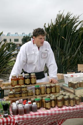 Rokas Armonas sells honey from Marshall's Farm at Ram Plaza on April 19. JOSEPH PHILLIPS / THE GUARDSMAN