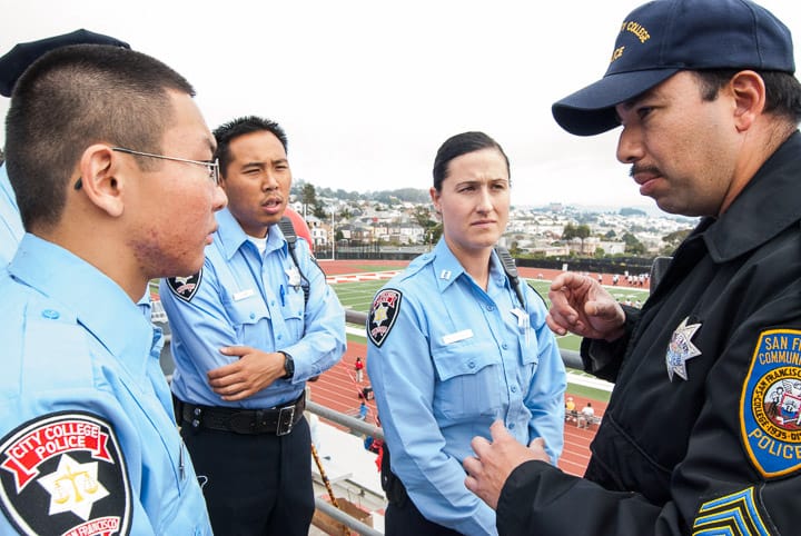 A group of City College student police officers Bryan Louie, 21, Jason Ho, 25 and Nicole Scherle, 25, listen to San Francisco Community College District police Sgt. Carlos Gaytan brief them on the duties before a football game at Rams Stadium on Ocean campus Nov. 2, 2013. Photo by Ekevara Kitpowsong/The Guardsman