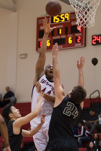 San Francisco Rams sophomore center Kanu Aja (44) hook shots  against the Ohlone College Renegades in a CCCAA men’s basketball game on Ocean campus, Friday, Feb. 22, 2014. The Rams won the game 71-63, finishing the regular season 12-0 undefeated. They won the Coast-North Conference title and will compete in playoffs next week. Photo by Santiago Mejia/The Guardsman