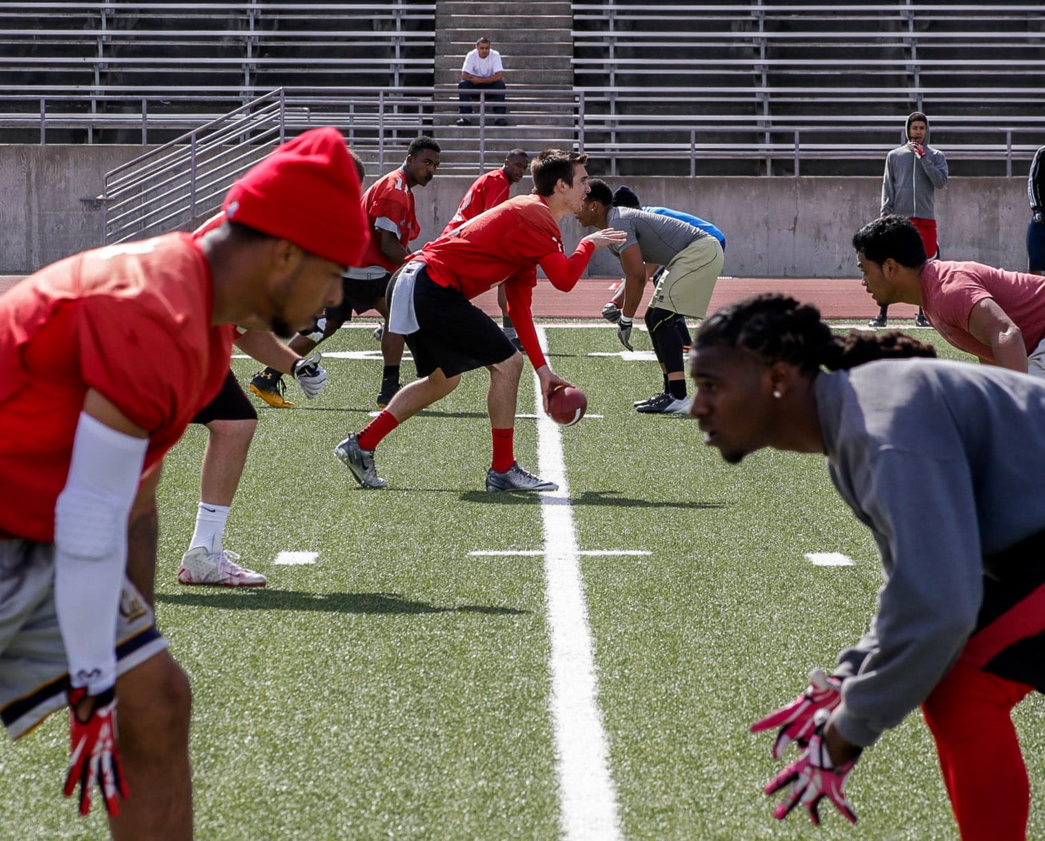 The City College football team forms at the line of scrimmage during practice, Saturday, April 19, 2014. Photo by Elisa Parrino/The Guardsman