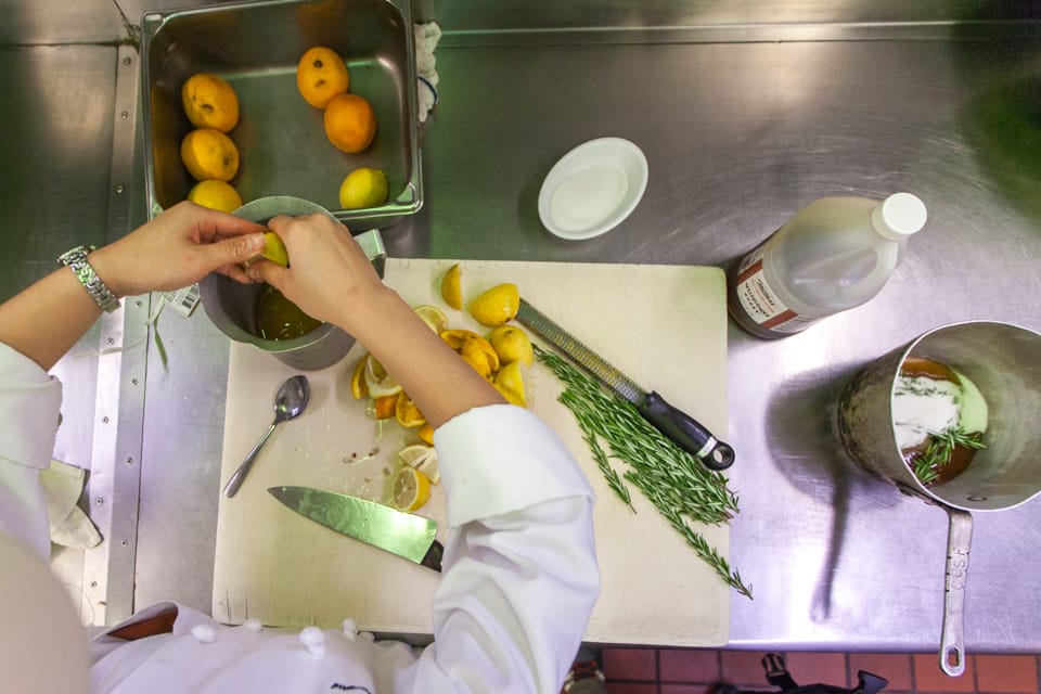 Sarinee Wangpongkul, a third semester Culinary Arts and Hospitality Studies student, hand squeezes lemons for the rosemary citrus sparkling on Wednesday, Aug. 27, 2014 at City College’s Radius 99.  Each week Radius 99 offers a new specialty drink prepared from a students original recipe.(Photo by Nathaniel Y. Downes) 