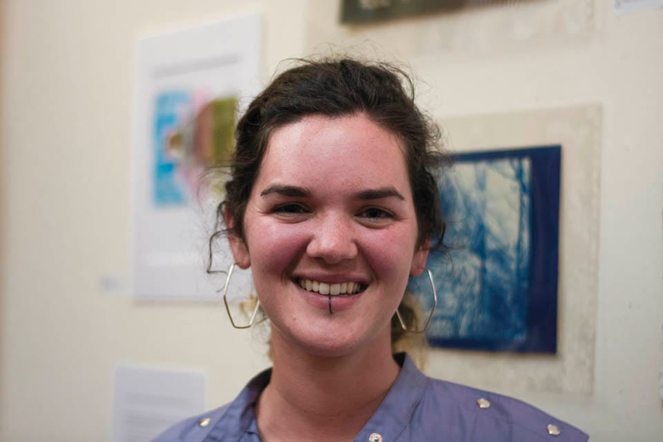 Briana Shewan, co-organizer of CCSF Mixed Media Art exhibit, celebrates at the opening reception on Thursday, Sept. 11, at Modern Times Bookstore in San Francisco’s Mission District.  (Photo by Niko Plagakis)