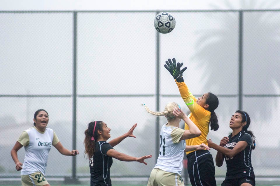 Cassie Stansberry #8 and Brenda Flores #28, jump for the cross late in the 2nd half of Friday’s home game against Ohlone College. (Photo by Niko Plagakis)
