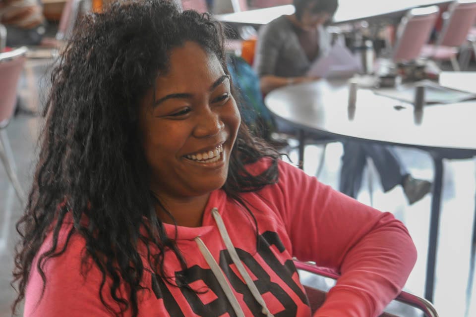 Carida Ward, a guardian scholar, laughs during a homework session, Oct. 10. (Photo by Natasha Dangond)