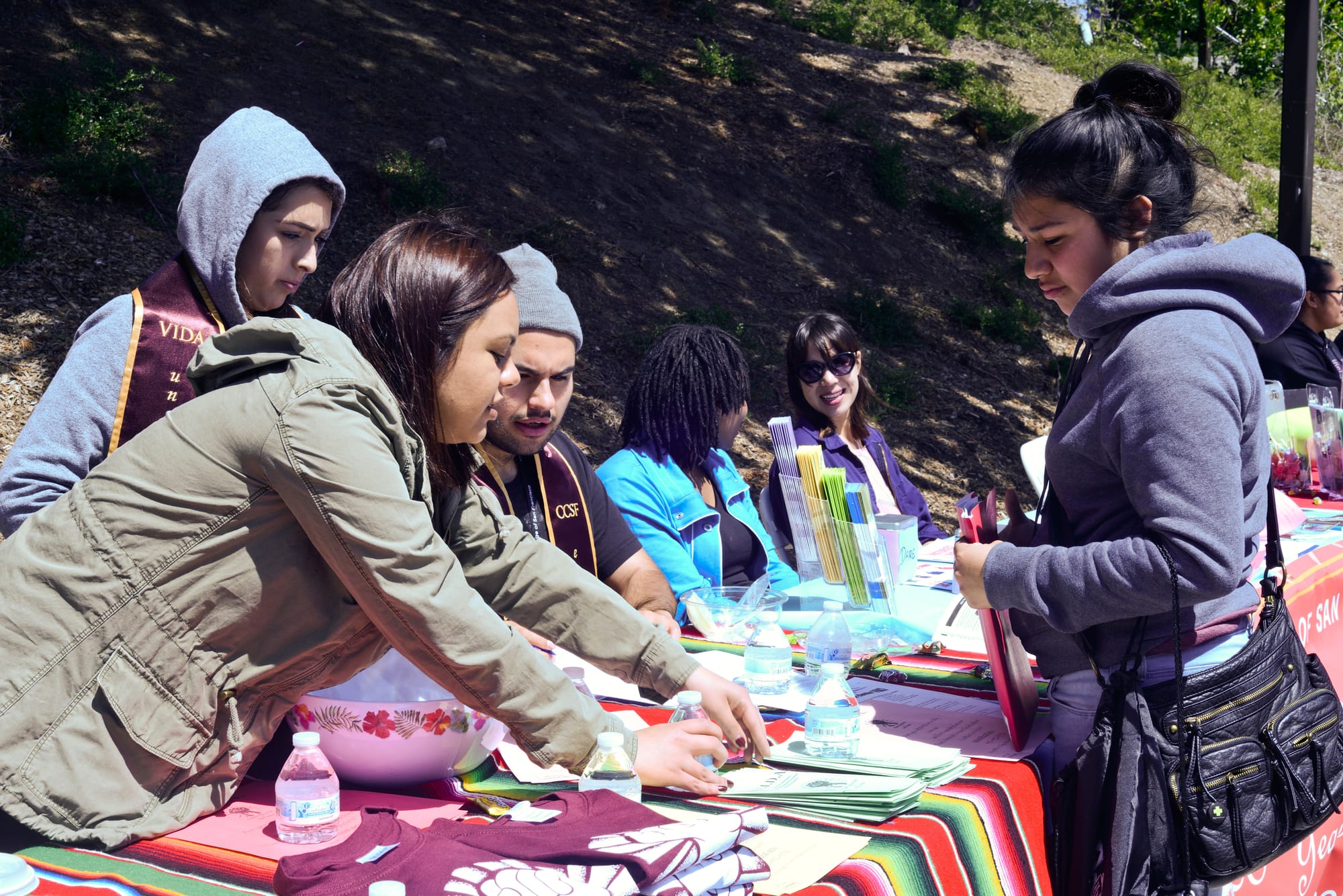 Martha Garcia helps out student and hands out information on Deferred Action for Childhood Arrivals (DACA) eligibility on Frisco Day at City College on Friday April 24, 2015.  
