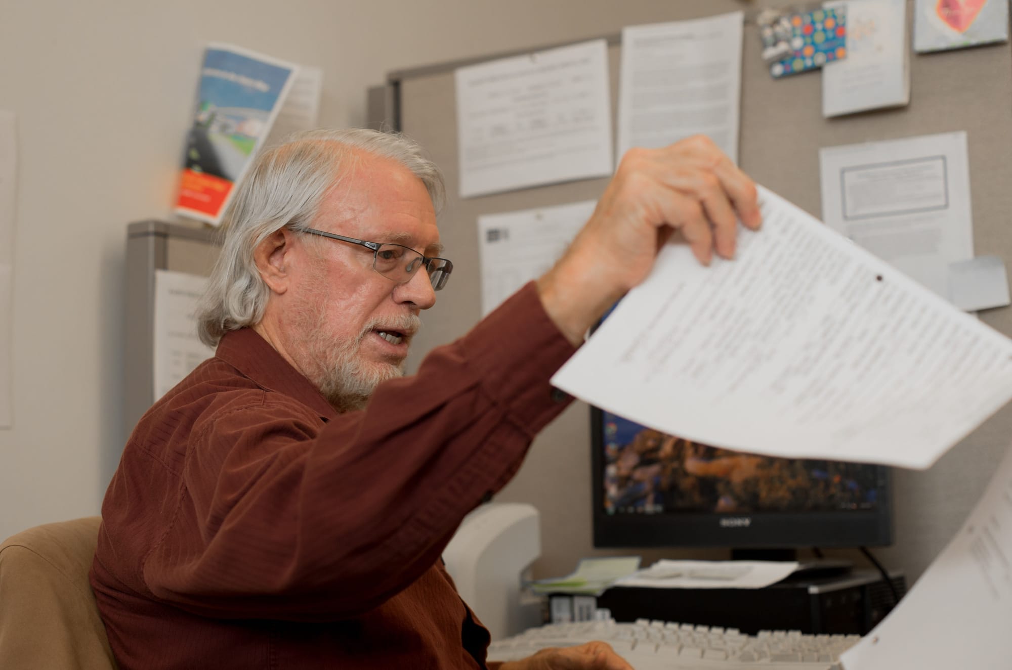 HARTS Director Chris Schaeffer pores over student data in the HARTS office Tuesday, Sept. 15, 2015. (Photo by Otto Pippenger/The Guardsman)