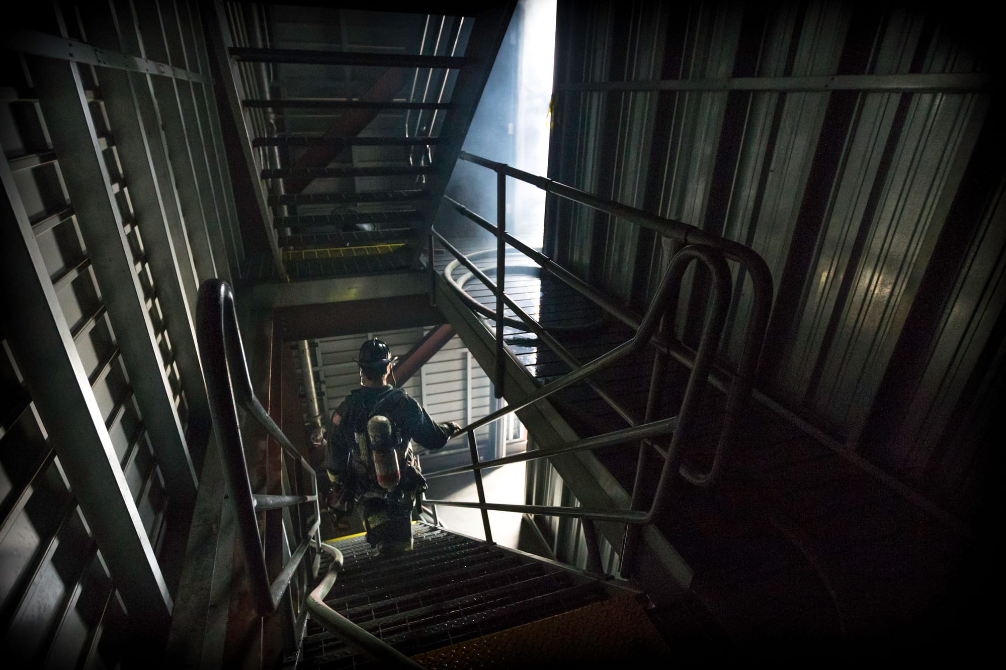A fire cadet heads out of the South San Francisco Fire Department’s darkened training tower during the live fire drill that cumulated the 18 weeks training for 29 fire cadets of City College’s Class 15 Fire Fighter One Academy on Saturday, May 16, 2015. (Photo by Nathaniel Y. Downes/The Guardsman)