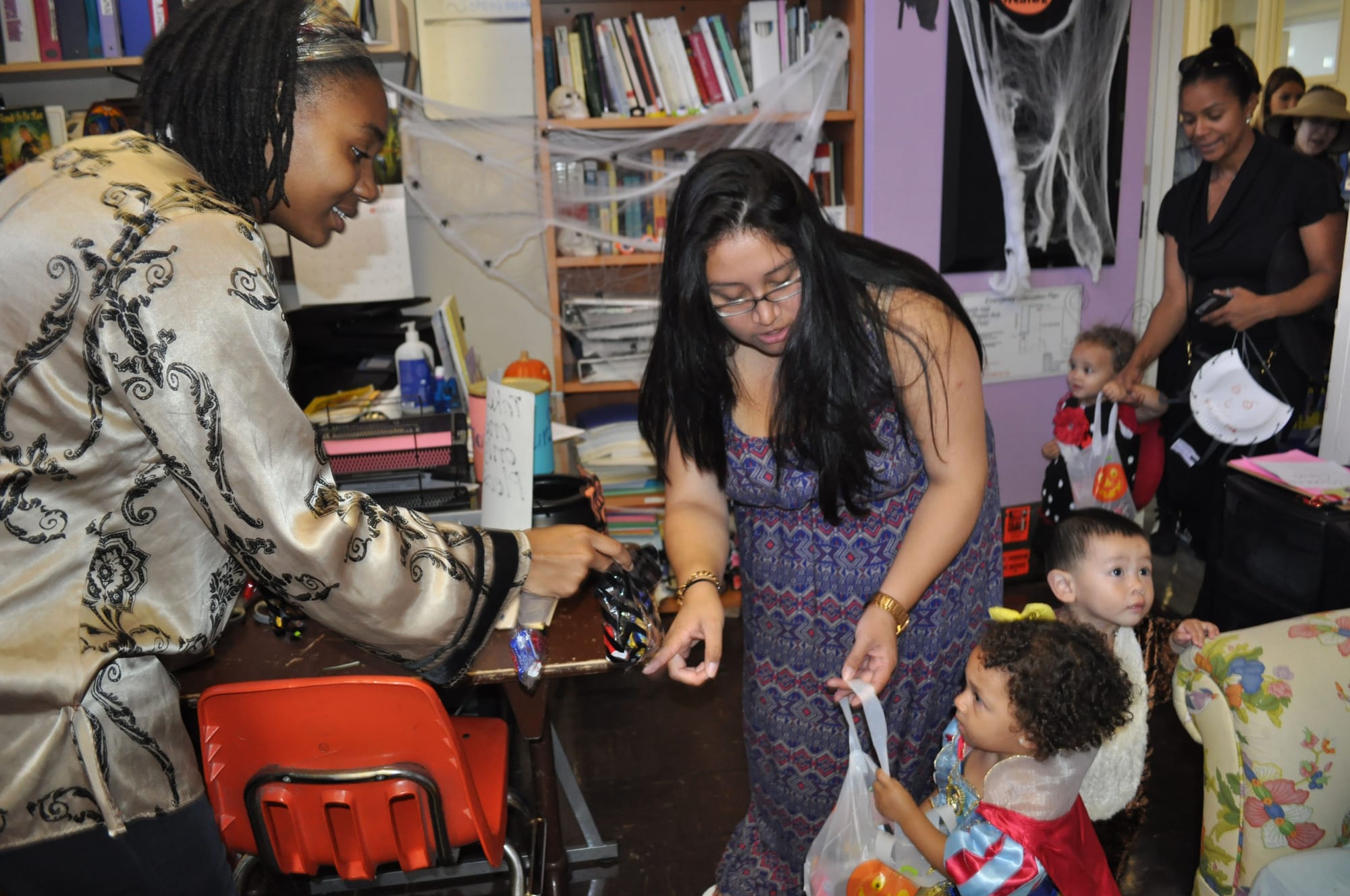 Women’s Resource Center staff offer trick-or-treaters from the Family Resource Center candy to celebrate Halloween at Ocean campus.