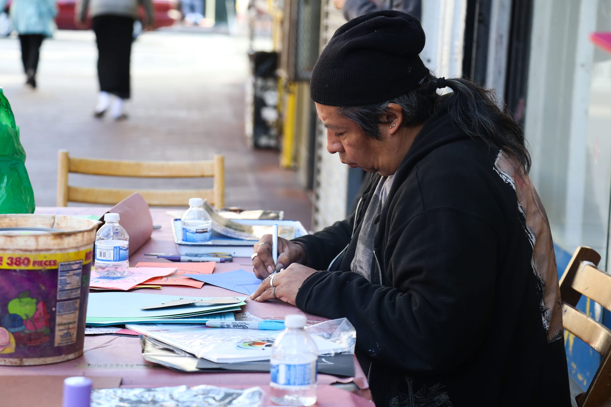  Txutxo Perez, a CAP staff member, drawing at the sidewalk art table at 1009 Market St.