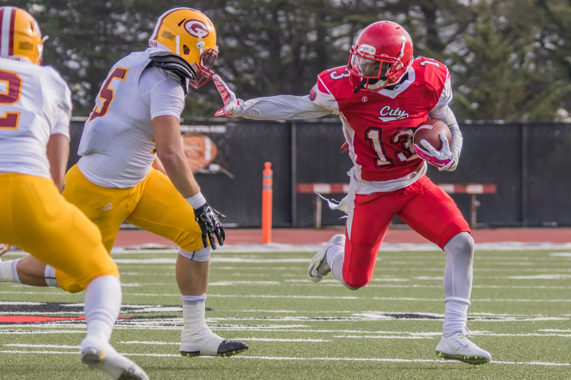 Namane Modise, #13 freshman running back preparing for a “stiff arm”. California State Championship. George M. Rush Stadium 12-12, photo by Peter Wong / The Guardsman.