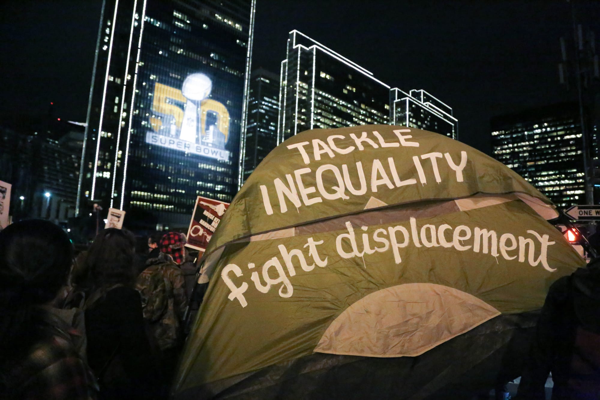 Hundreds of activists marched the perimeter of Super Bowl City (Photo by Gabriella Angotti-Jones)