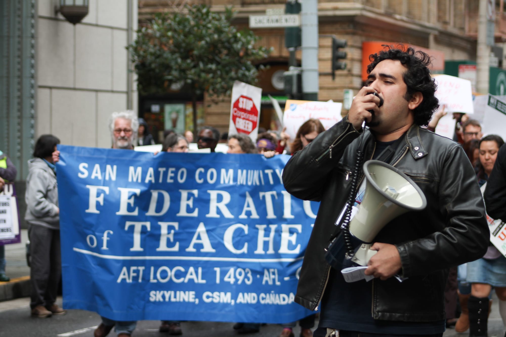 A protester calls for higher quality public education through his megaphone as faculty, students, and community members march around him on March 11, 2016. (Audrey Garces/The Guardsman) 